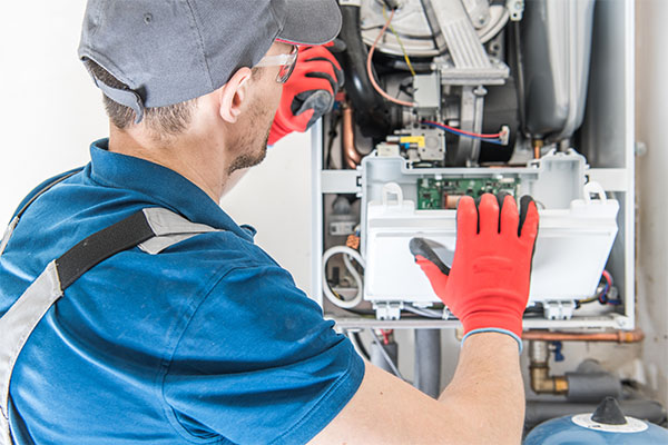 hvac worker installing heater in home 